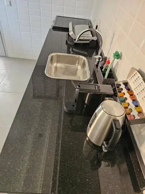 a kitchen counter with a sink and a pot at Family Stay Ourzazate - Deluxe Appartments in Ouarzazate