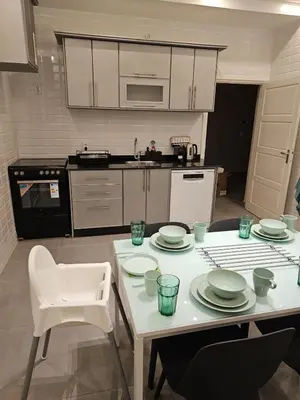 a kitchen with a table with plates on it at Family Stay Ourzazate - Deluxe Appartments in Ouarzazate