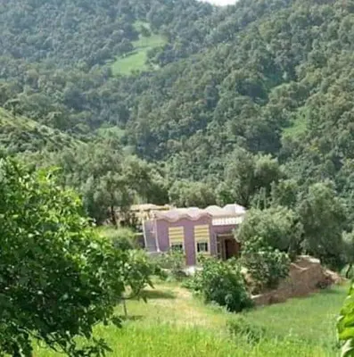 a house in the middle of a mountain at Park tazeka in Bistouna
