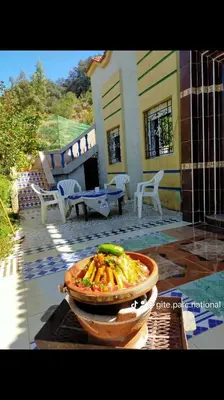 a bowl of food in front of a house at Park tazeka in Bistouna