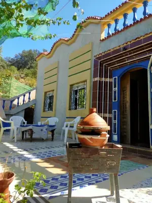 a house with a vase on a table in front of it at Park tazeka in Bistouna