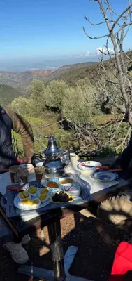 a picnic table with food on it with a view at Park tazeka in Bistouna