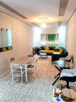 a living room with a couch and a table at Comfortable apartment Meknes in Meknès