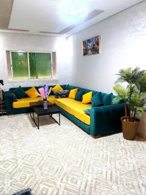 a living room with a blue and yellow couch at Comfortable apartment Meknes in Meknès