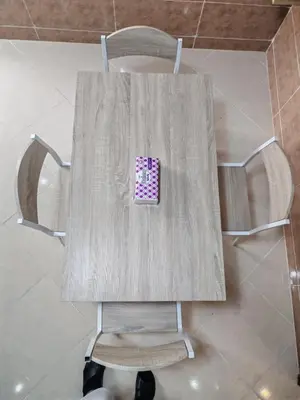 a table with a chair with a sticker on it at Comfortable apartment Meknes in Meknès