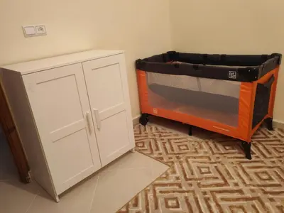 a kitchen with a stove and a white cabinet at Comfortable apartment Meknes in Meknès