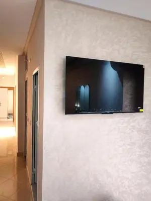 a flat screen tv on a wall in a room at Comfortable apartment Meknes in Meknès