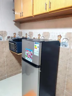 a kitchen with a refrigerator and a stove at Comfortable apartment Meknes in Meknès