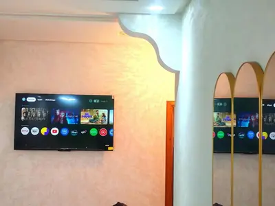 a tv on a wall with surfboards on it at Comfortable apartment Meknes in Meknès