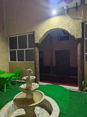 a fountain in the middle of a room with green grass at Gite ritch in Rich