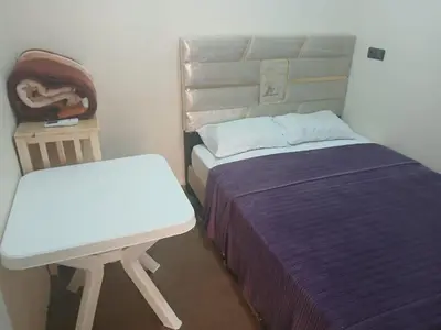 a small bedroom with a bed and a chair at Gite ritch in Rich