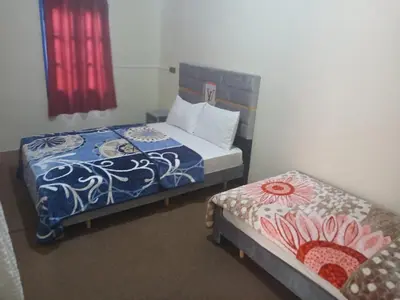 a bedroom with two beds with blue and white sheets at Gite ritch in Rich