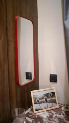 a mirror on a wall with a picture on a table at Penthouse-fes in Fès