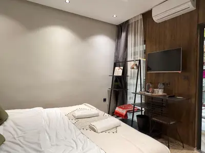 a bedroom with a bed and a flat screen tv at Penthouse-fes in Fès
