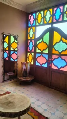 a room with a colorful stained glass window at Kasbat Taslit chez l'habitant in Tajda