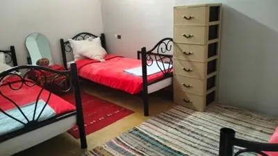 a bedroom with two bunk beds and a dresser at Kasbat Taslit chez l'habitant in Tajda