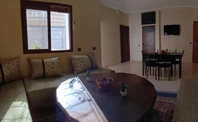 a living room with a couch and a table at Beautiful apartment near airport in Fès