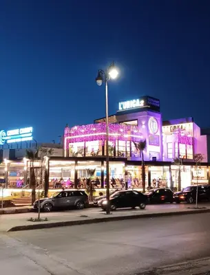a building with cars parked in front of it at night at Beautiful apartment near airport in Fès