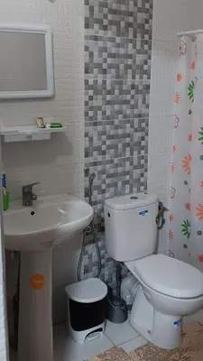 a bathroom with a white toilet and a sink at Chez Khalid, near airport in Fès