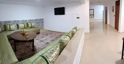 a living room with a couch and a table at Chez Khalid, near airport in Fès