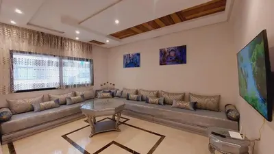 a large living room with a couch and a table at Tanger Apt Near Train & Mall in Oulad Akkou