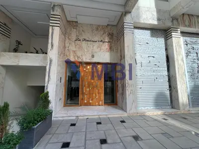 an entrance to a building with a wooden door at Tanger Apt Near Train & Mall in Oulad Akkou