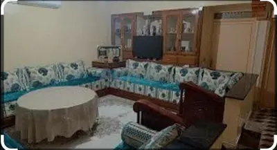 a living room with a couch and a table at Maison Zakaria in Zaouiat Cheikh