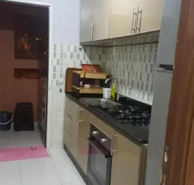 a kitchen with a stove and a counter top at Maison Zakaria in Zaouiat Cheikh