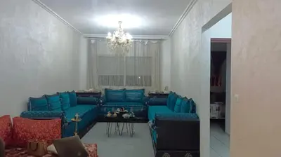 a living room with blue couches and a table at Appartement Ghita in Fès