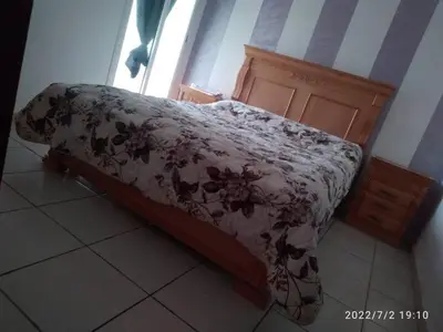 a bed in a room with a blanket on it at Appartement Ghita in Fès