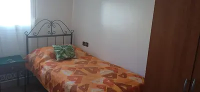 a bedroom with a bed with a pillow on it at Joli appartement de 120 m2 in Meknès