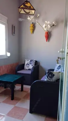 a living room with two chairs and a table at Joli appartement de 120 m2 in Meknès