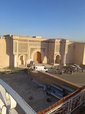a building with a bunch of people in front of it at Joli appartement de 120 m2 in Meknès