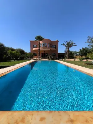 a large swimming pool in front of a house at Domaine du souffle d Amaia in Had Abdallah Rhiat
