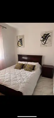 a bed with two pillows on it in a bedroom at Welcome Home in Oulad Hammou