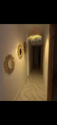a hallway with two mirrors on the wall at Welcome Home in Oulad Hammou