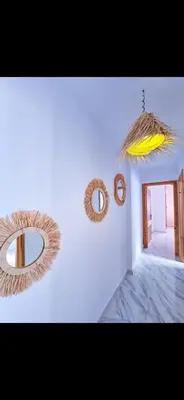 a room with two mirrors on a white wall at Welcome Home in Oulad Hammou
