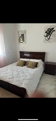 a bed with two pillows on it in a bedroom at Welcome Home in Oulad Hammou