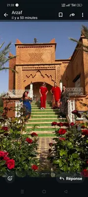 a group of people standing on the steps of a building at Chez l'habitant tigminnagh in Ouarzazate