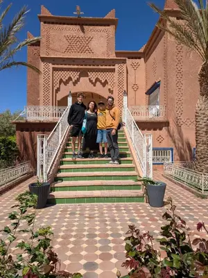 a group of people standing on the stairs of a house at Chez l'habitant tigminnagh in Ouarzazate