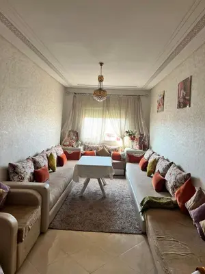 a living room with a couch and a table at Bloc A3 AP161 ET4 nakhil lamsala Meknès in Meknès