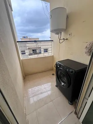 a washing machine in a room with a balcony at Bloc A3 AP161 ET4 nakhil lamsala Meknès in Meknès