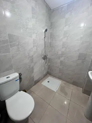 a bathroom with a white toilet and a sink at Bloc A3 AP161 ET4 nakhil lamsala Meknès in Meknès
