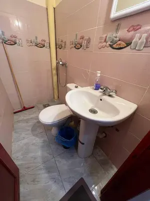 a bathroom with a sink and a toilet at Residence Dallas Warzazate in Ouarzazate