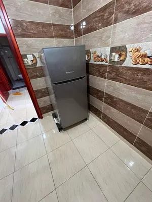 a refrigerator in the corner of a room at Residence Dallas Warzazate in Ouarzazate