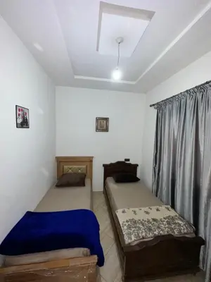 a bedroom with two beds and a window in it at Appartement neuf meublé pour location journalière in Fès