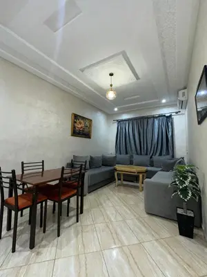 a living room with a couch and a table at Appartement neuf meublé pour location journalière in Fès