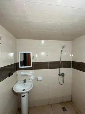 a bathroom with a sink and a shower at Appartement neuf meublé pour location journalière in Fès