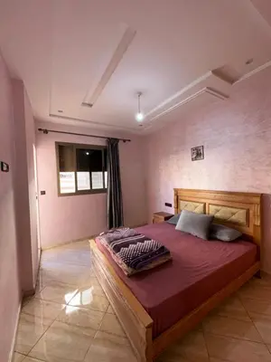 a bedroom with a large bed in a room at Appartement neuf meublé pour location journalière in Fès
