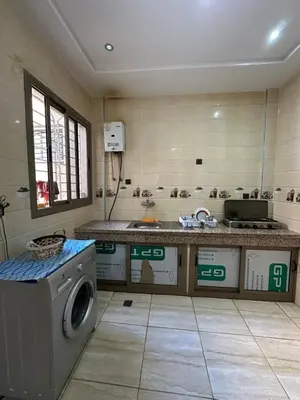a kitchen with a sink and a washing machine at Appartement neuf meublé pour location journalière in Fès
